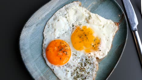 Two-fried-eggs-in-a-plate-top-view
