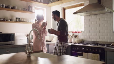 a-couple-enjoying-coffee-in-their-kitchen-at-home