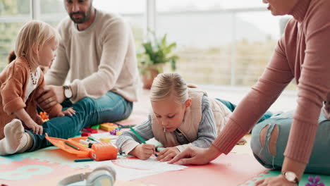 Parents,-children-and-drawing-on-floor-in-home