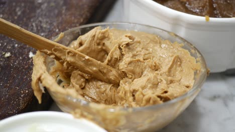 Close-up-of-fresh-peanut-butter-in-a-container-,