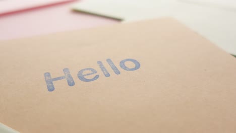Close-up-of-hello-text-in-blue--on-a-envelope