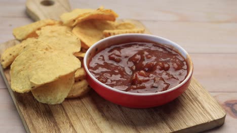 A-bowl-of-chips-and-salsa-on-table