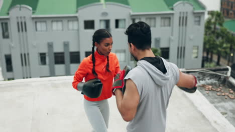 Boxing,-woman-and-rooftop-with-personal-trainer