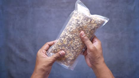 Men-holding-a-packet-of-granola-musli