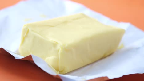 Slice-of-a-butter-on-a-paper-on-table