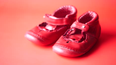 Childrens-shoes-on-red--background