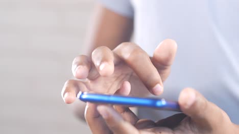 Close-up-of-young-man-hand-using-smart-phone