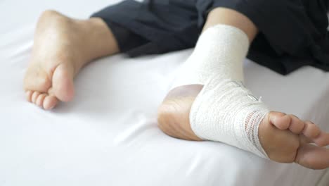 Woman-with-bandaged-foot-on-bed
