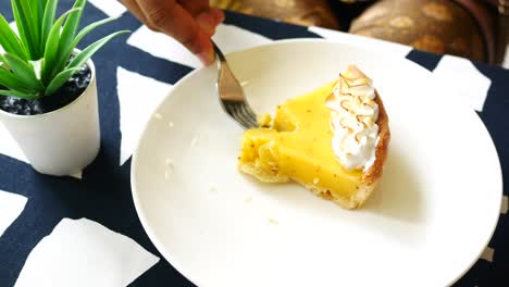 Over-head-view-of-women-eating-lemon-tart-,