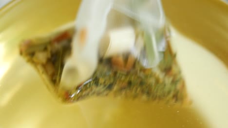Green-tea-and-tea-bag-on-table,-close-up