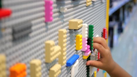 Child-hand-playing-with-ful-building-block