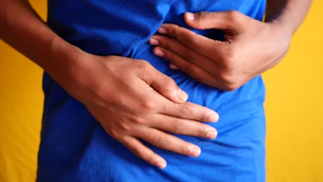 Young-man-suffering-stomach-pain-close-up