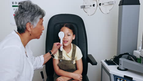 Eye-exam,-patient-and-optician-cover-child-vision