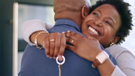 Couple,-hug-or-happy-with-house-keys-of-new-home