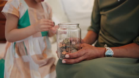 Coins,-jar-or-hands-of-mother-with-child-counting