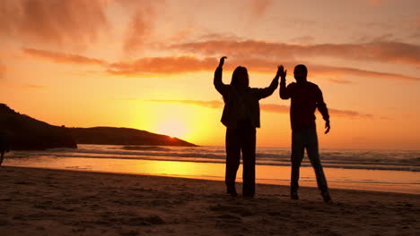 Couple,-silhouette-and-dancing-at-beach