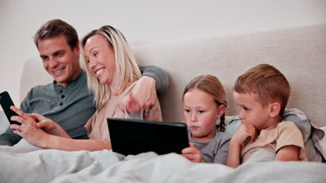 Parents,-children-and-tablet-in-bedroom