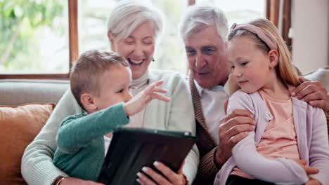 Children,-grandparents-and-tablet-on-sofa