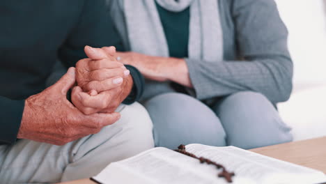 Senior-couple,-bible-study-and-rosary-with-hands