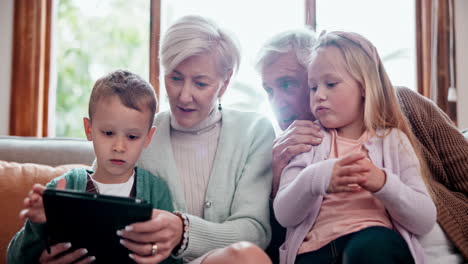Children,-grandparents-and-tablet-on-sofa