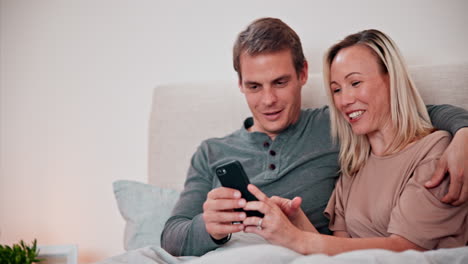 Couple,-phone-and-smile-in-bedroom-for-social