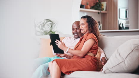 Smile,-tablet-and-funny-couple-on-sofa-in-home