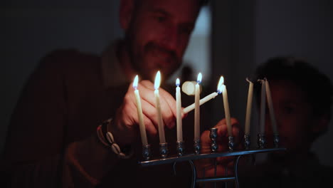 Jewish,-holiday-and-a-family-lighting-candles