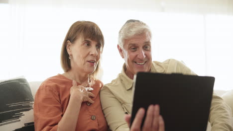 Tablet,-wave-and-video-call-with-a-senior-couple