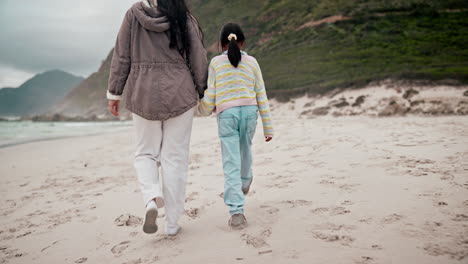 Back,-beach-and-a-mother-holding-hands