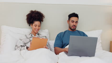 Couple,-tablet-and-laptop-with-talking-in-bed