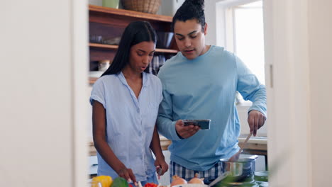 Cooking,-recipe-and-phone-of-couple-in-a-kitchen