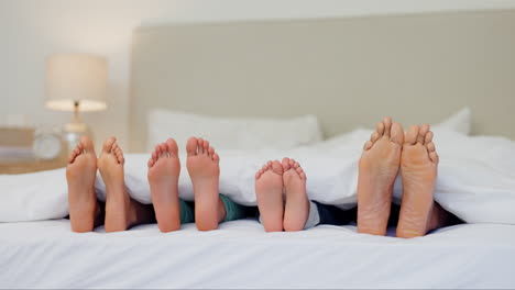 Sleeping,-feet-and-family-in-a-bed-relax