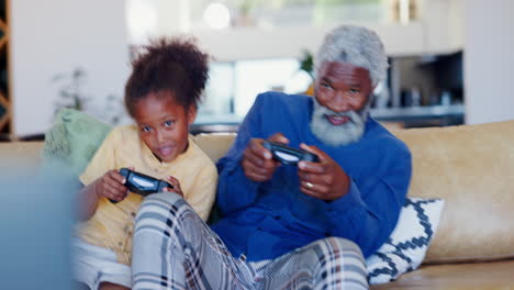 Child,-grandfather-and-video-games-on-sofa