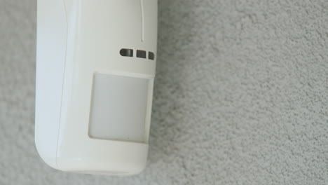 Motion-sensor-on-the-wall-of-the-house.-LED-indicators-light-up-to-detect-movement