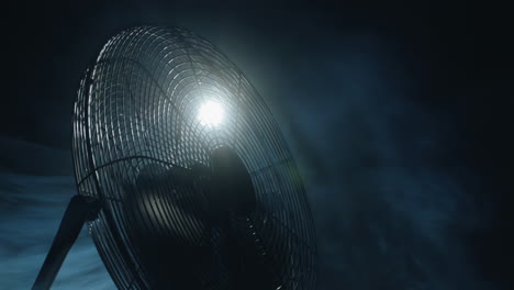 Fan-blades-rotate-in-rays-of-light-and-fog.-Slider-shot