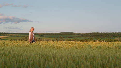 Woman-farmer-walking-through-a-picturesque-field-of-wheat