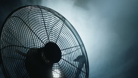 Fan-blades-rotate-in-rays-of-light-and-fog.-Close-up-shot
