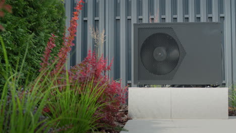 The-heat-pump-for-heating-the-pool-is-mounted-on-site.-Ornamental-plants-nearby.-Energy-Saving-Technologies.-4k-video