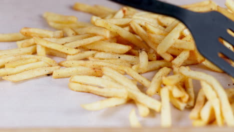 Fast-food,-french-fries-and-spatula-for-cooking
