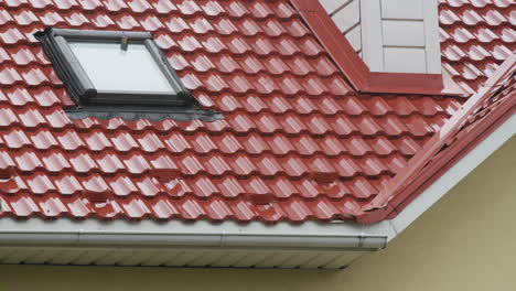 Rainwater-flows-down-the-tiled-roof-into-the-drainpipe