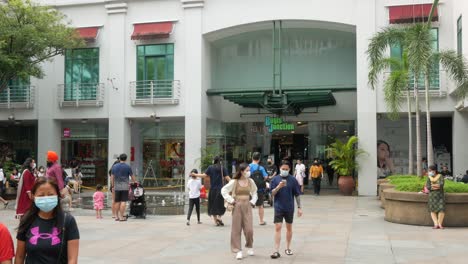 Singapore-bugis-street-2-june-2022-shopper-walking-on-open-space-in-bugis-retail-mall-buildings