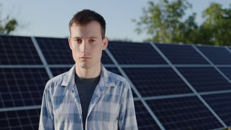 Portrait-of-a-young-man-against-the-background-of-solar-power-plant-panels