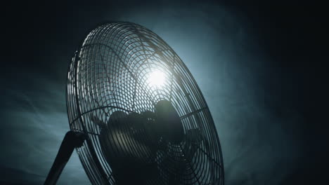 Fan-blades-rotate-in-rays-of-light-and-fog.-Slider-shot