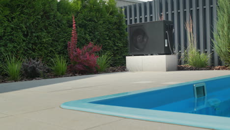 A-small-swimming-pool,-next-to-it-is-visible-a-heat-pump-for-heating-water.-Energy-Saving-Technologies