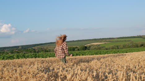 A-teenage-girl-runs-through-a-picturesque-wheat-field.-Slow-motion-video