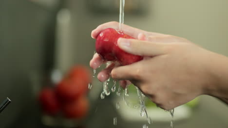 Frauenhände-Waschen-Einen-Saftigen-Pfirsich-Unter-Leitungswasser.-Zeitlupenvideo