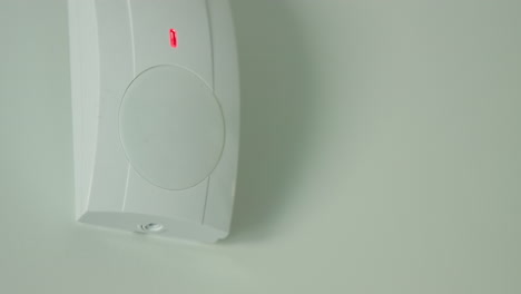 The-motion-sensor-alarm-is-triggered.-The-red-LED-on-the-sensor-lights-up