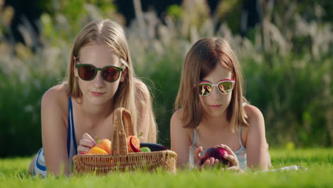 Two-friends-on-a-picnic,-near-them-a-basket-of-fresh-vegetables