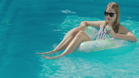 A-teenage-girl-floats-in-an-inflatable-circle-on-the-surface-of-the-pool