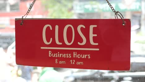 Closed-sign-hanging-on-door-of-cafe